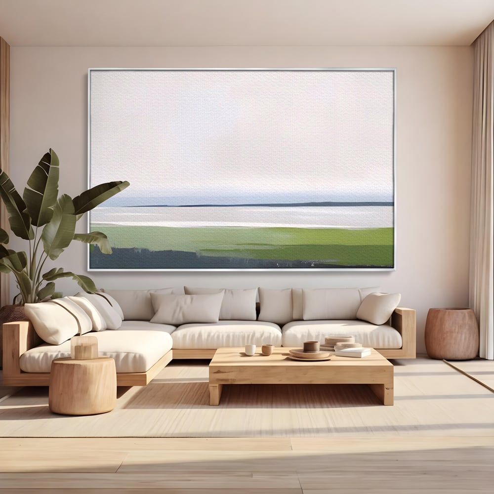 Tablou canvas cu pictura orizontala cu peisaj de campie si apa, in rama de aluminiu argintiu, pe perete intr-un living